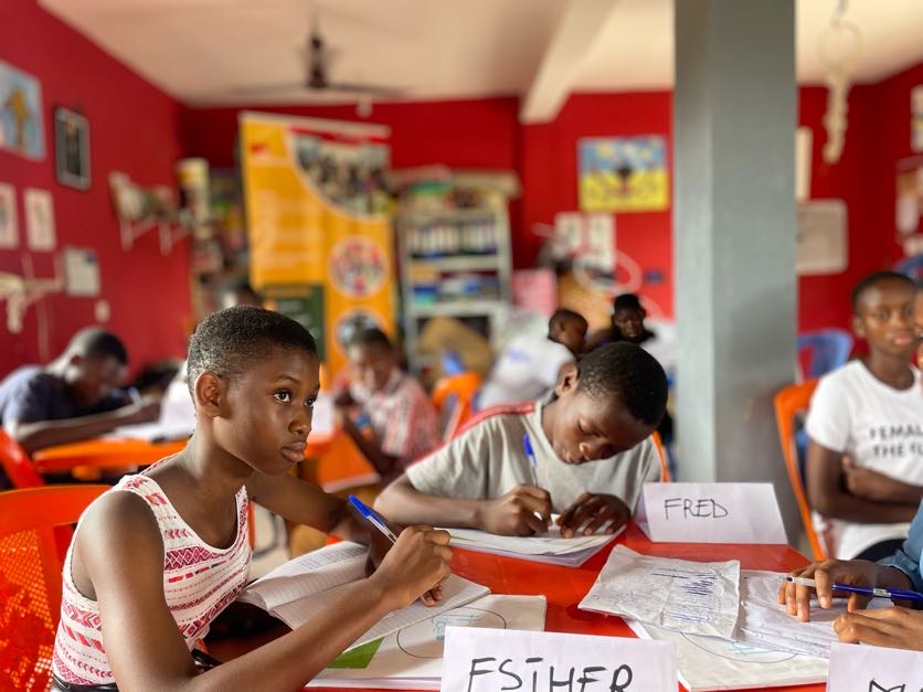 Students write in their notebooks during a lesson at the Learning Hub.